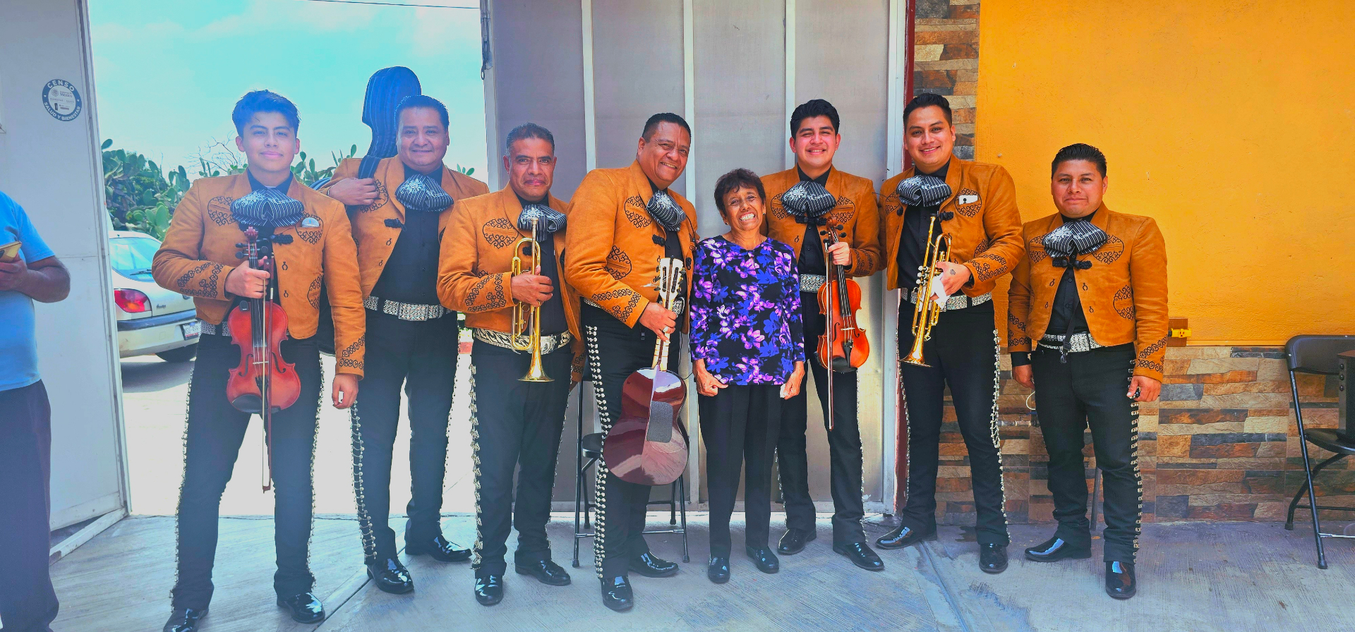 Mariachi completo posando con cliente al terminar el evento
